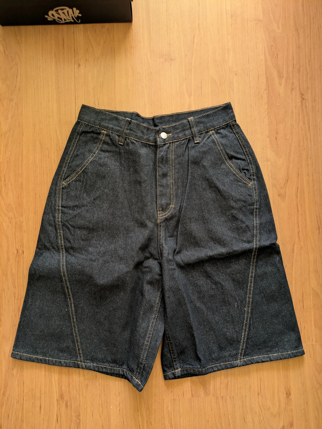 Front of the dark denim shorts