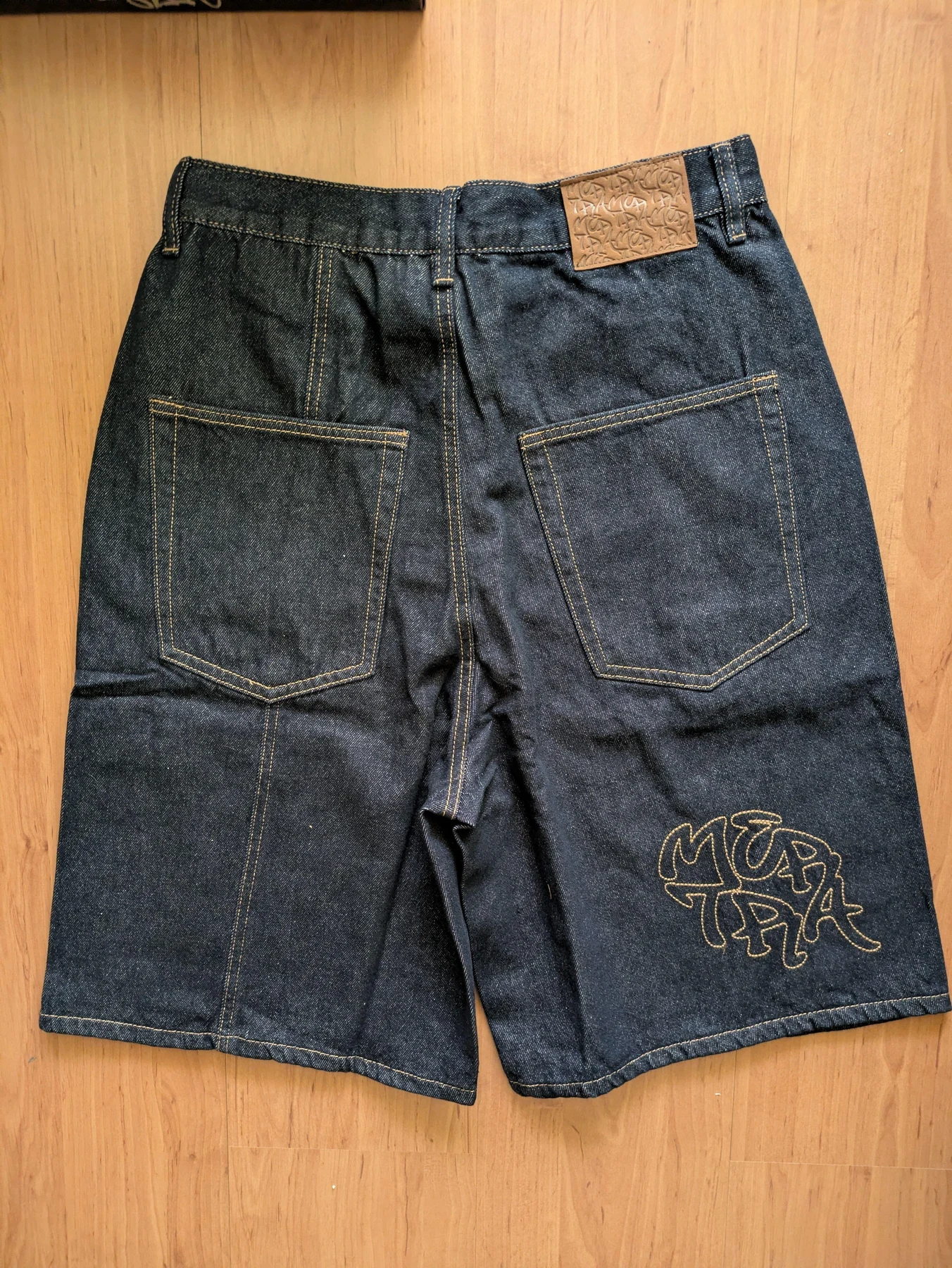 Back pocket details on the dark shorts