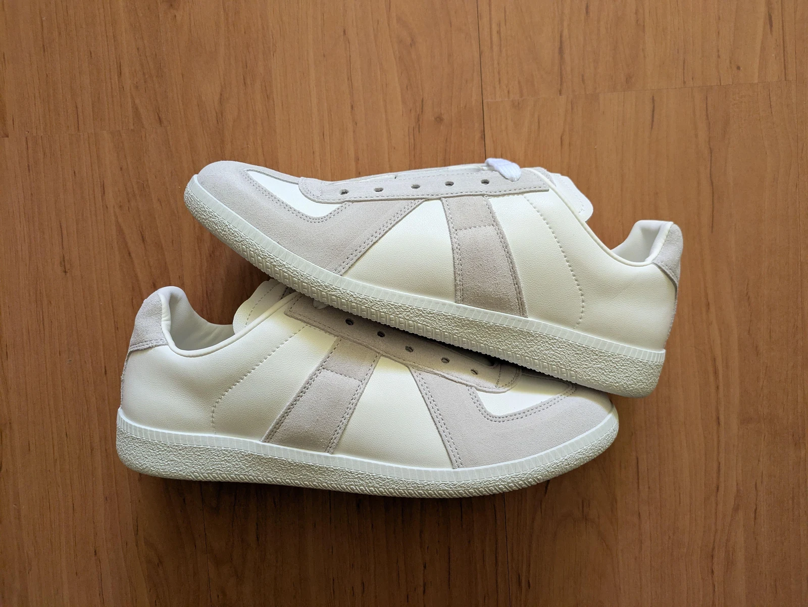 Light MM6-style sneaker pair
