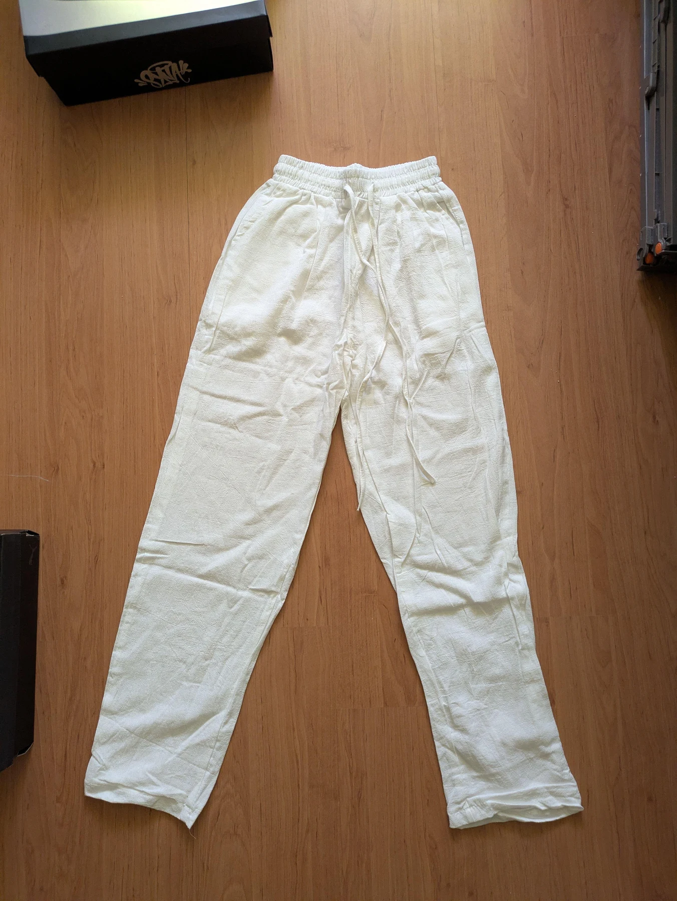 Light trousers laid flat